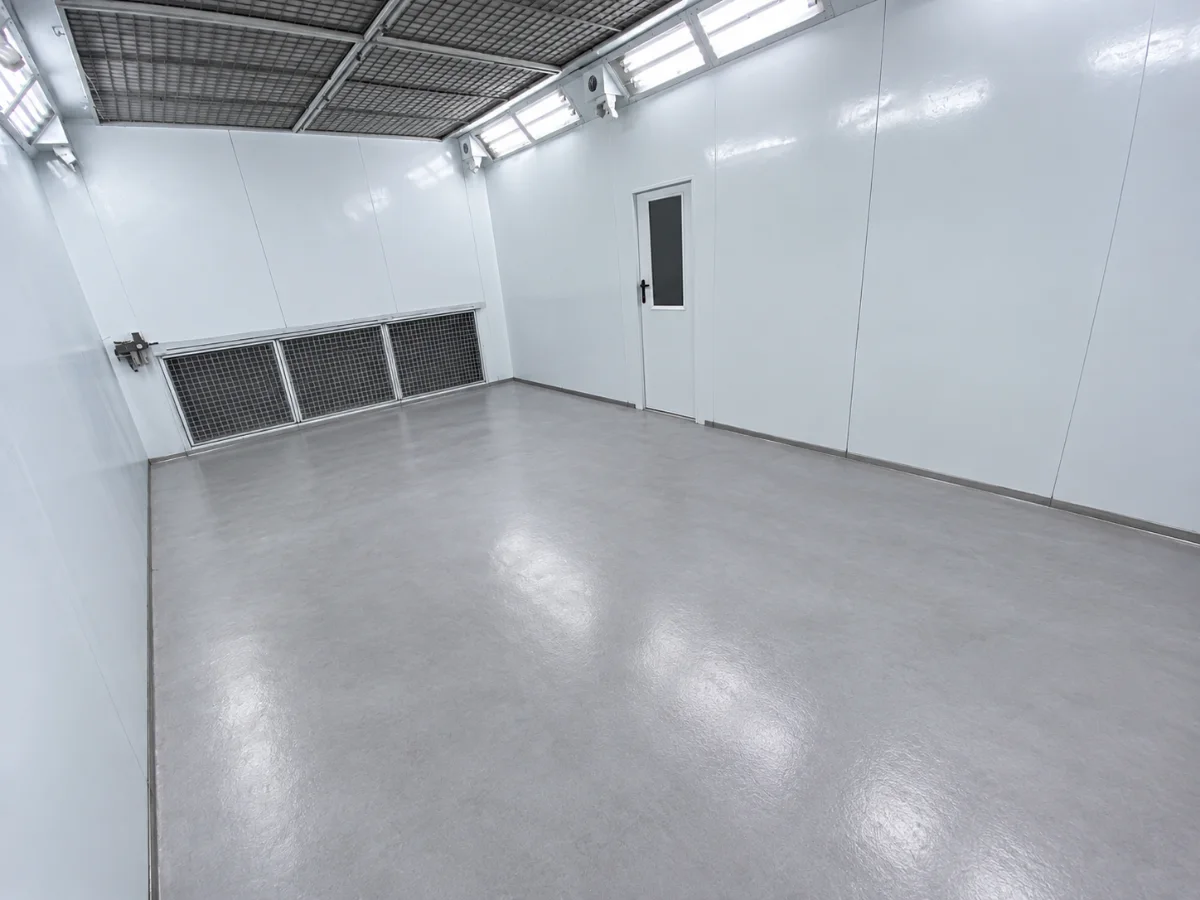 Inside the spray booth, lit and prepped before a respray