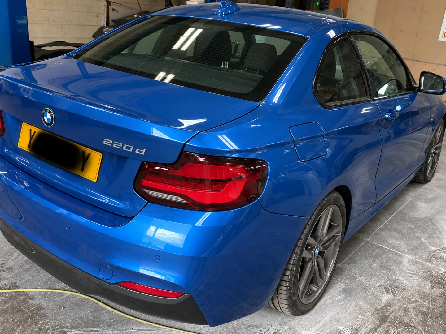 The same BMW 2 Series finished, resprayed in metallic blue with the panels blended